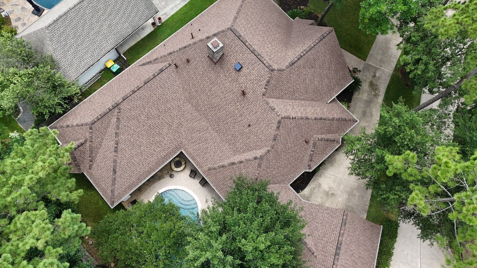 Aerial view of a completed IKO roof replaced by Northvale Roofing on a Woodlands, TX home — an approved insurance claim
