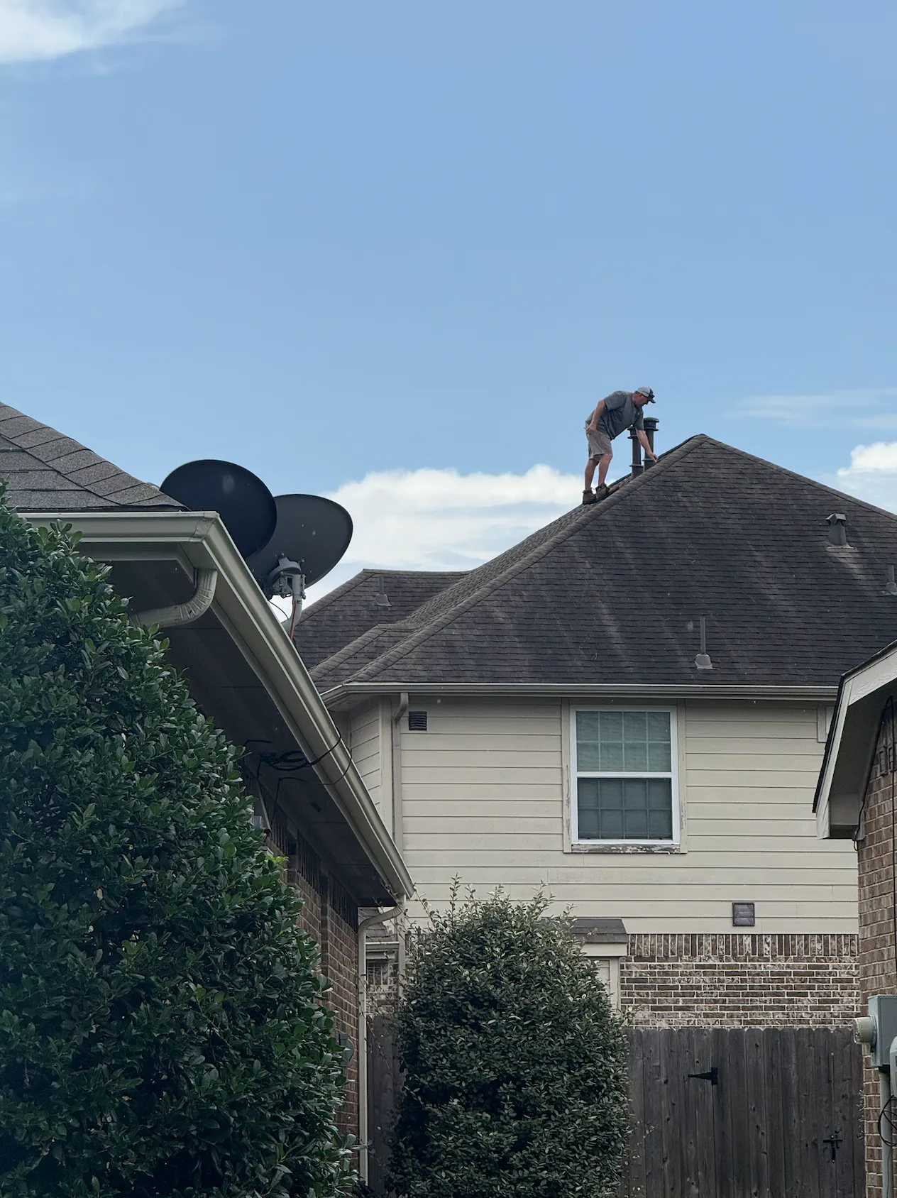 Northvale Roofing team member walking a steep two-story roof