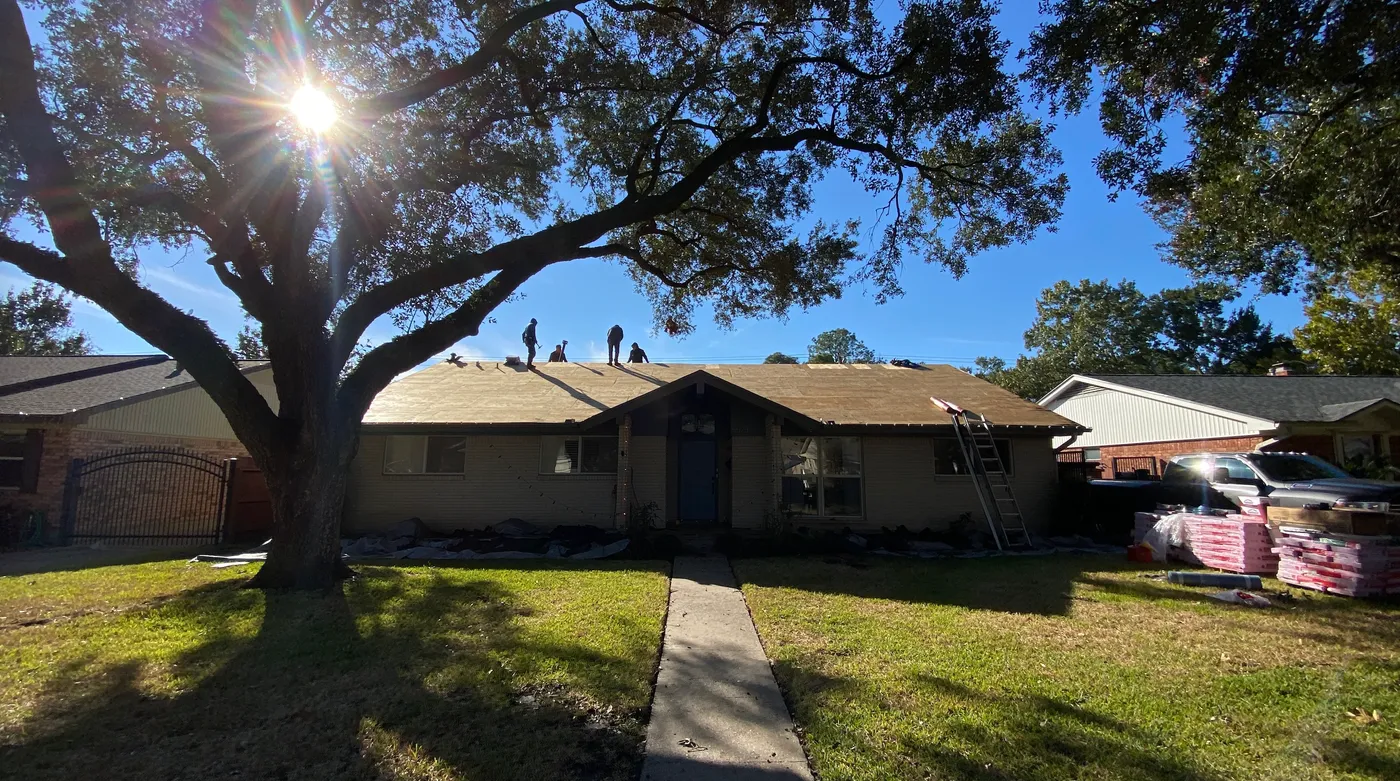 Northvale Roofing crew mid tear-off on a single-story home