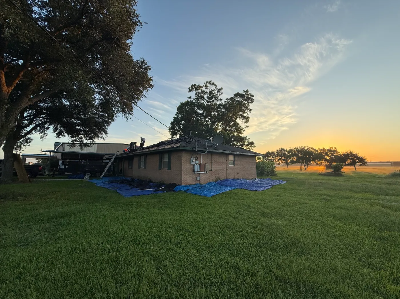 Home and landscaping protected with tarps during a Northvale re-roof