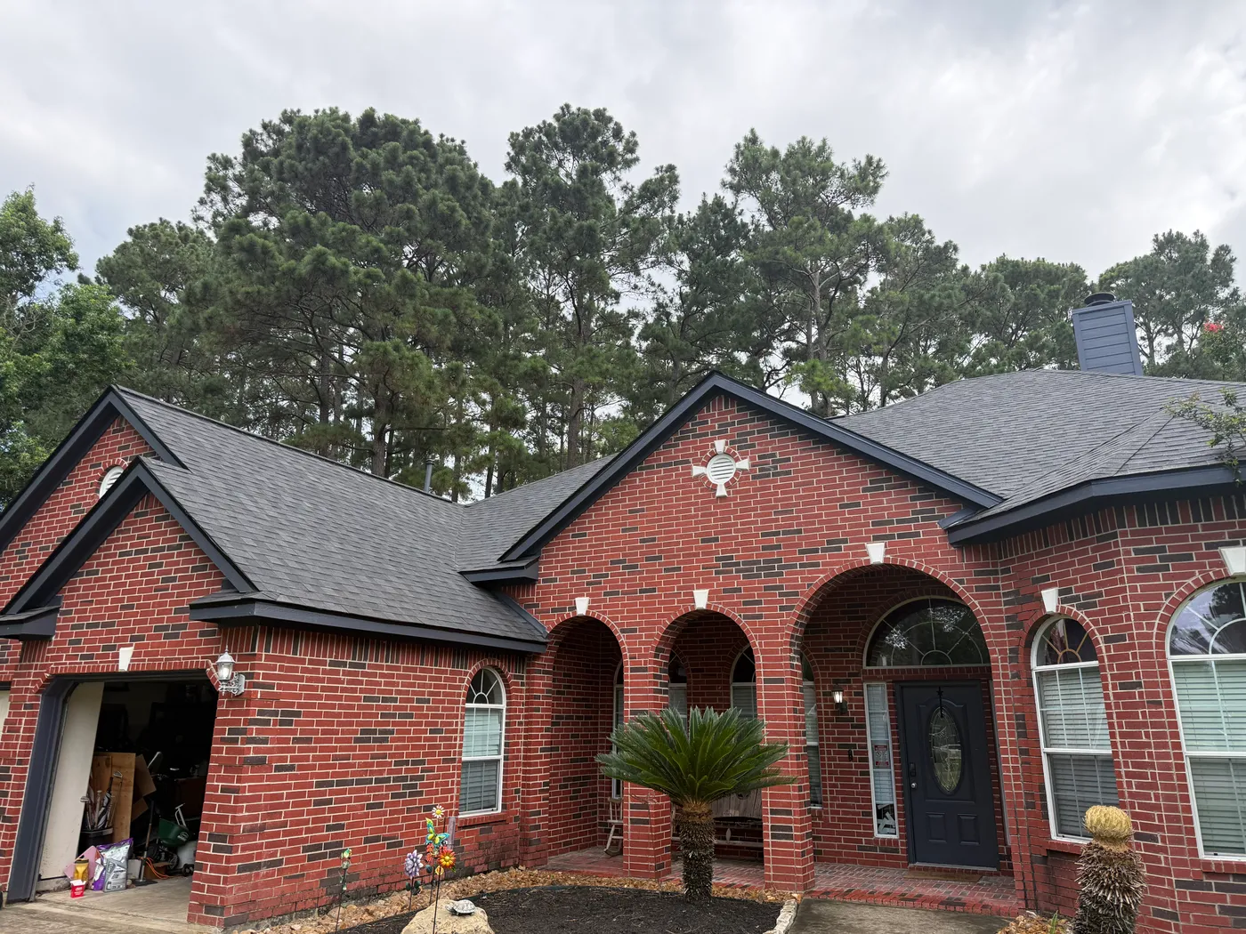 Completed Northvale Roofing shingle roof replacement on a red-brick home